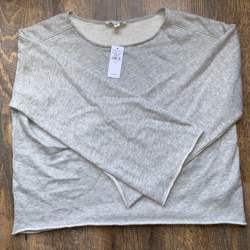 Grey American Eagle long sleeve flared arm shirt.